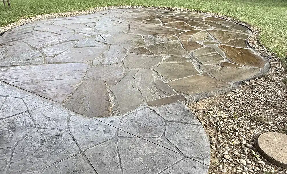 Landscape installation with decorative stone and planting beds